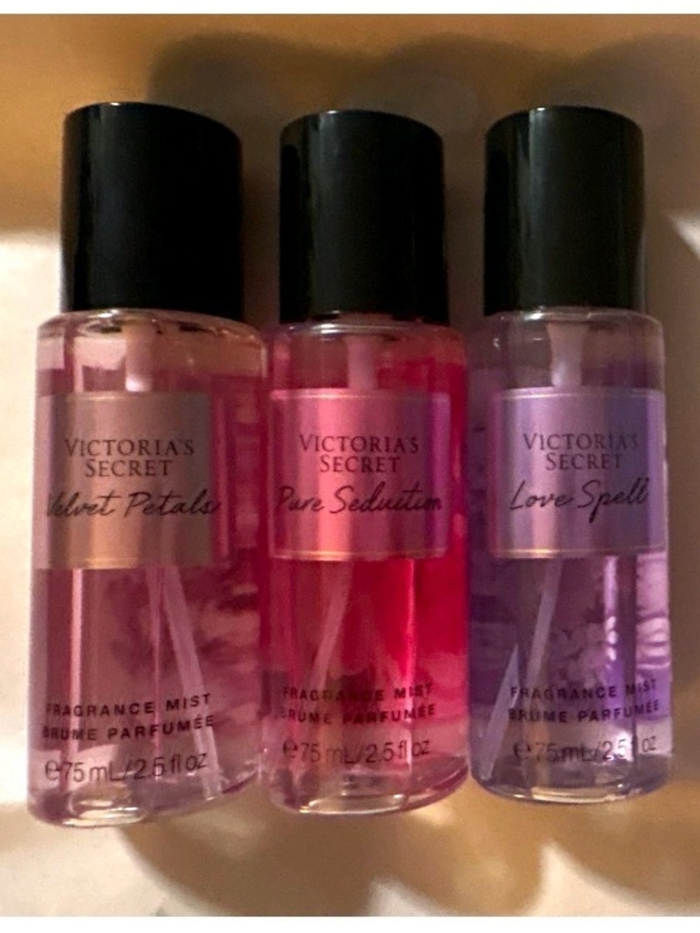 Victoria's Secret fragrance mist trio in pink, red, and purple